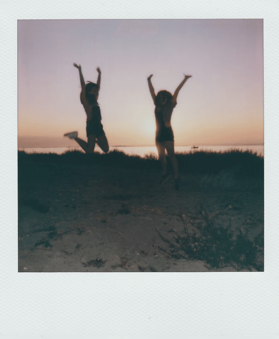 Friends jumping in the air at sunset